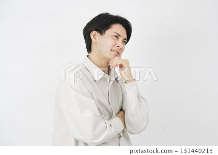 Man in his 20s worried white background Man in his 20s worried white background 131440213