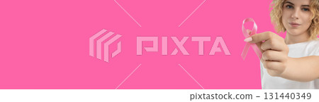 A person holds pink ribbons to promote cancer awareness 131440349