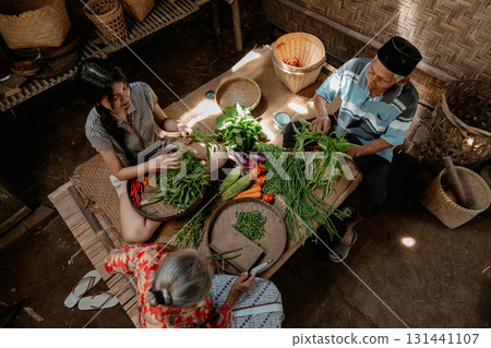 Engaging in Traditional Food Preparation Together with Family in a Rustic Setting 131441107