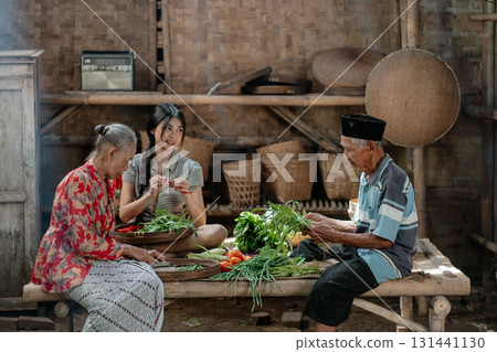 Traditional Gathering in a Rustic Kitchen Preparing Delicious Fresh Vegetables 131441130