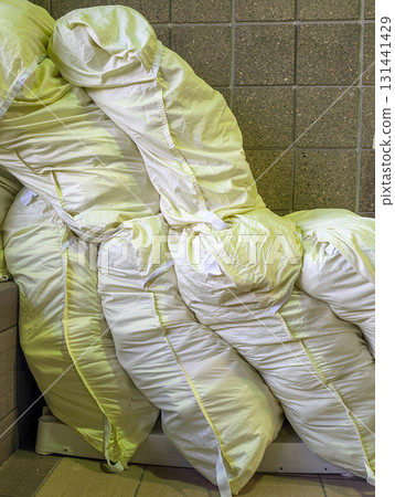 Piled white laundry bags in a storage area showcasing organization and cleanliness 131441429