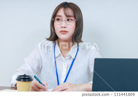 A young lady working on desk work A young lady working on desk work 131441809