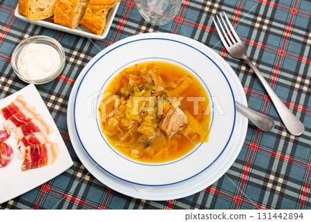 Shchi cooked from sauerkraut with pork meat served with sour cream Shchi cooked from sauerkraut with pork meat served with sour cream 131442894