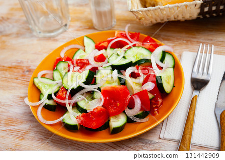 Vegetarian salad with fresh cucumbers, tomatoes, onion Vegetarian salad with fresh cucumbers, tomatoes, onion 131442909