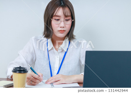 Businesswoman staring at a PC monitor Businesswoman staring at a PC monitor 131442944