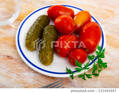Appetizing pickled cucumbers and tomatoes 131442947