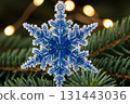 Glitter Snowflake Ornament Hanging On Christmas Tree 131443036