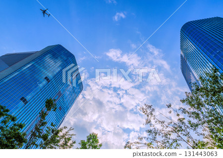 Tokyo cityscape in Japan. View of Takanawa Gateway City in front of Takanawa Gateway Station. Aircraft in the sky (F series) 131443063