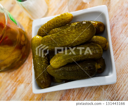 Pickled cucumbers on white plate, homemade preserves 131443166