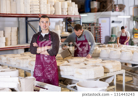Young man posing at ceramic factory 131443243