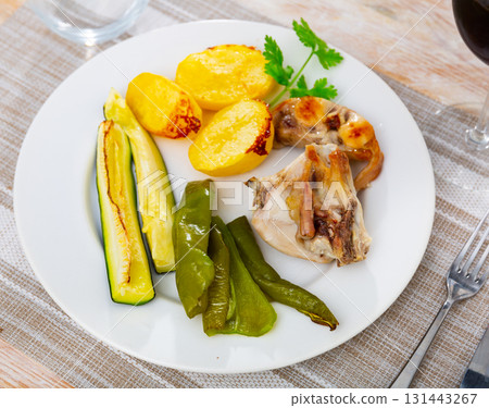 Roasted rabbit served with vegetable garnish Roasted rabbit served with vegetable garnish 131443267
