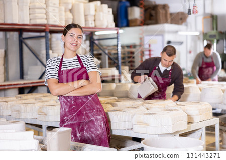 Young woman posing at ceramic factory Young woman posing at ceramic factory 131443271