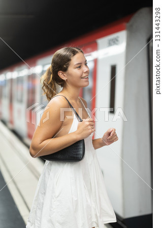 Young girl getting into metro wagon 131443298
