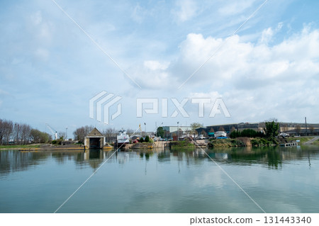 A Serene and Picturesque Waterside View Featuring Reflection and Beautiful Cloudy Skies 131443340