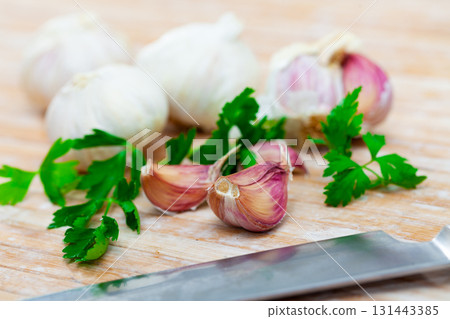 Parsley and garlic on wooden table Parsley and garlic on wooden table 131443385