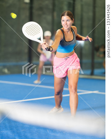 Young and adult women playing doubles tennis 131443426