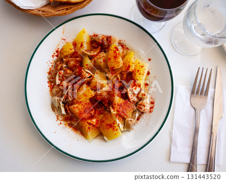 Galician dish of stewed pigs ear with pepper and potatoes 131443520
