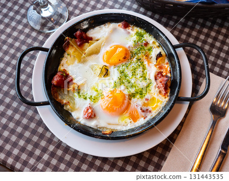 Riojan style eggs casserole with potatoes, bell peppers, sausages 131443535