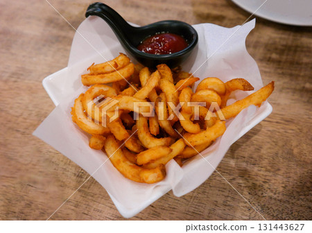 fresh curly fries in cup in restaurant fresh curly fries in cup in restaurant 131443627