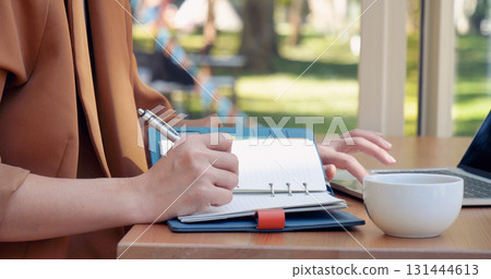 Woman working business office desk using laptop work from home. Businesswoman looking financial business chart, graph, infographic analyze sale statistics. Woman hands on entrepreneur office desk Woman working business office desk using laptop work from home. Businesswoman looking financial business chart, graph, infographic analyze sale statistics. Woman hands on entrepreneur office desk 131444613