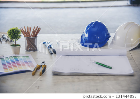 construction engineer office desk architect workplace. engineer drawing objects table with meter, blueprint, hard hat engineering stuff on desk. Designer Objects drafting workplace on wooden table. 131444855