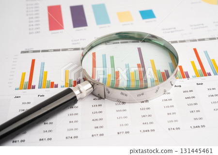 Magnifying glass on graph paper. Financial development, Banking Account, Statistics, Investment Analytic research data economy, Business. 131445461
