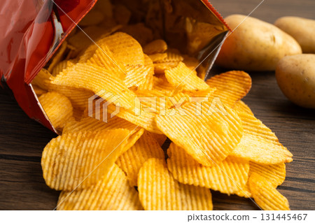 Potato chips, delicious BBQ seasoning spicy for crips, thin slice deep fried snack fast food in open bag. Potato chips, delicious BBQ seasoning spicy for crips, thin slice deep fried snack fast food in open bag. 131445467