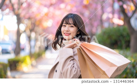 Smiling woman shopping with shopping bags 131446364