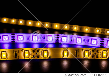 Close-up of colorful LED strips with yellow and purple glow Close-up of colorful LED strips with yellow and purple glow 131446453