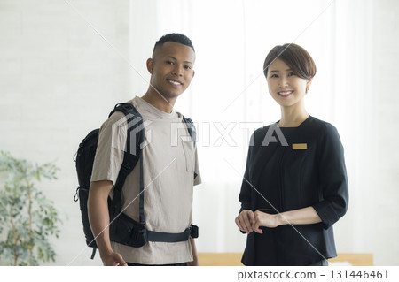 A female hotel attendant explaining things to a foreign man 131446461