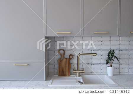 Grey with gold details, modern minimalist kitchen, wooden cutting board, alocasia Grey with gold details, modern minimalist kitchen, wooden cutting board, alocasia 131446512