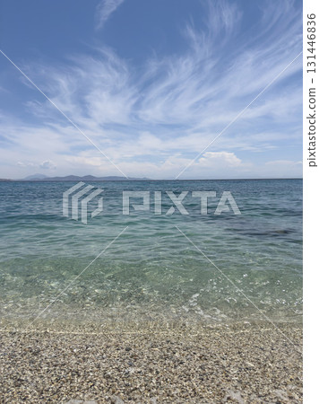 beautiful calm Sea on Pebble Beach and Wispy Clouds under Blue Sky in summer. beautiful calm Sea on Pebble Beach and Wispy Clouds under Blue Sky in summer. 131446836