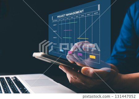 Project manager is working on virtual screen, using project management system. Gantt chart interface to plan tasks, schedule milestones, track progress, ensuring efficient project execution company. Project manager is working on virtual screen, using project management system. Gantt chart interface to plan tasks, schedule milestones, track progress, ensuring efficient project execution company. 131447052