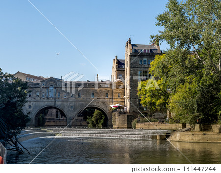 Historic Stone Bridge over Peaceful River Scene 131447244