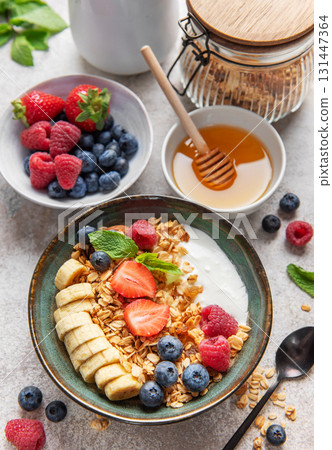 Delicious granola with yogurt, banana, and berries creating a nutritious breakfast 131447364