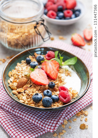 Granola bowl with fresh berries yogurt and nuts Granola bowl with fresh berries yogurt and nuts 131447366