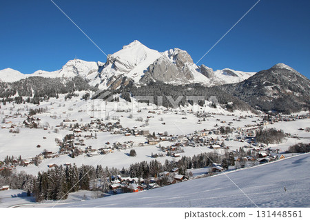 Village Wildhaus, mountains Santis and Altmann in winter, Switzerland. 131448561