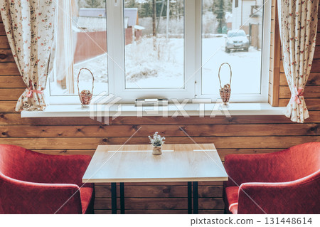 cozy indoor setting with wooden ambiance and winter view outside window. closeup. 131448614