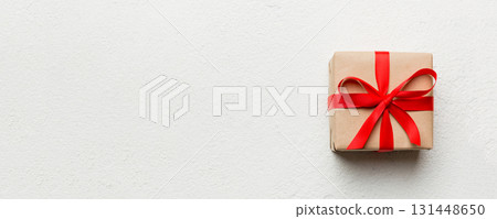 Valentine day composition: red gift box with bow and heart. Christmas present. View from above. Space for text. Holday greeting card 131448650