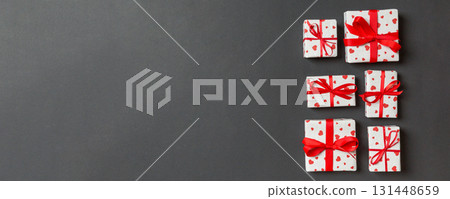 Top view colorful valentine background made of gift boxes with red hearts. Valentine's Day concept with copy space 131448659