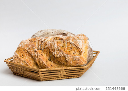 Freshly baked bread on basket against natural background. Perspective view bread copy space Freshly baked bread on basket against natural background. Perspective view bread copy space 131448666