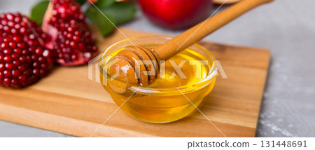 Rosh hashanah, jewish holiday, concept: honey, apple and pomegranate with cutting board, close up 131448691