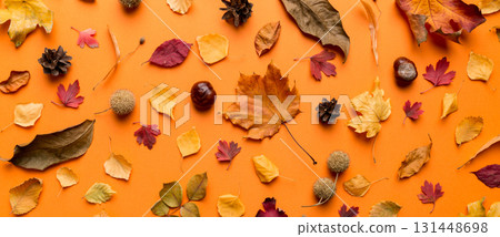 Autumn composition. Pattern made of dried leaves and other design accessories on table. Flat lay, top view Autumn composition. Pattern made of dried leaves and other design accessories on table. Flat lay, top view 131448698