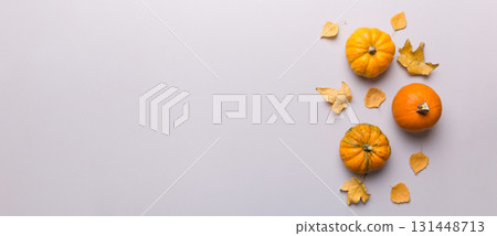 Autumn composition. Pattern made of dried leaves and other design accessories on table. Flat lay, top view Autumn composition. Pattern made of dried leaves and other design accessories on table. Flat lay, top view 131448713
