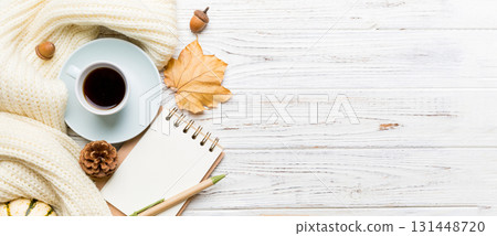 Autumn composition: fallen leaves and craft sketchbook mock up on colored background. Top view. Flat lay with copy space Autumn composition: fallen leaves and craft sketchbook mock up on colored background. Top view. Flat lay with copy space 131448720