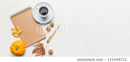 Autumn composition: fallen leaves and craft sketchbook mock up on colored background. Top view. Flat lay with copy space Autumn composition: fallen leaves and craft sketchbook mock up on colored background. Top view. Flat lay with copy space 131448722