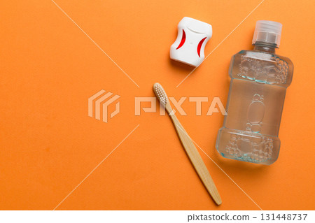 Mouthwash and other oral hygiene products on colored table top view with copy space. Flat lay. Dental hygiene. Oral care products and space for text on light background. concept 131448737
