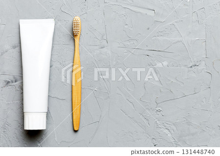 toothpaste and toothbrush top view with copy space on colored background. Flat lay. Dental hygiene. Oral care products on light background. Body care concept toothpaste and toothbrush top view with copy space on colored background. Flat lay. Dental hygiene. Oral care products on light background. Body care concept 131448740