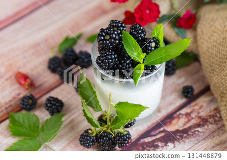Summer dessert of yogurt with berries and flowers Summer dessert of yogurt with berries and flowers 131448879