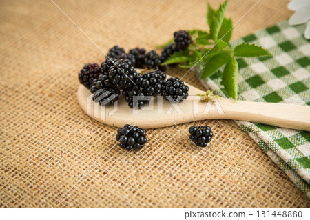 Ripe berries on table with fabric and greenery Ripe berries on table with fabric and greenery 131448880